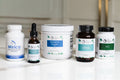 Collection of health and wellness products on a white surface with a neutral background