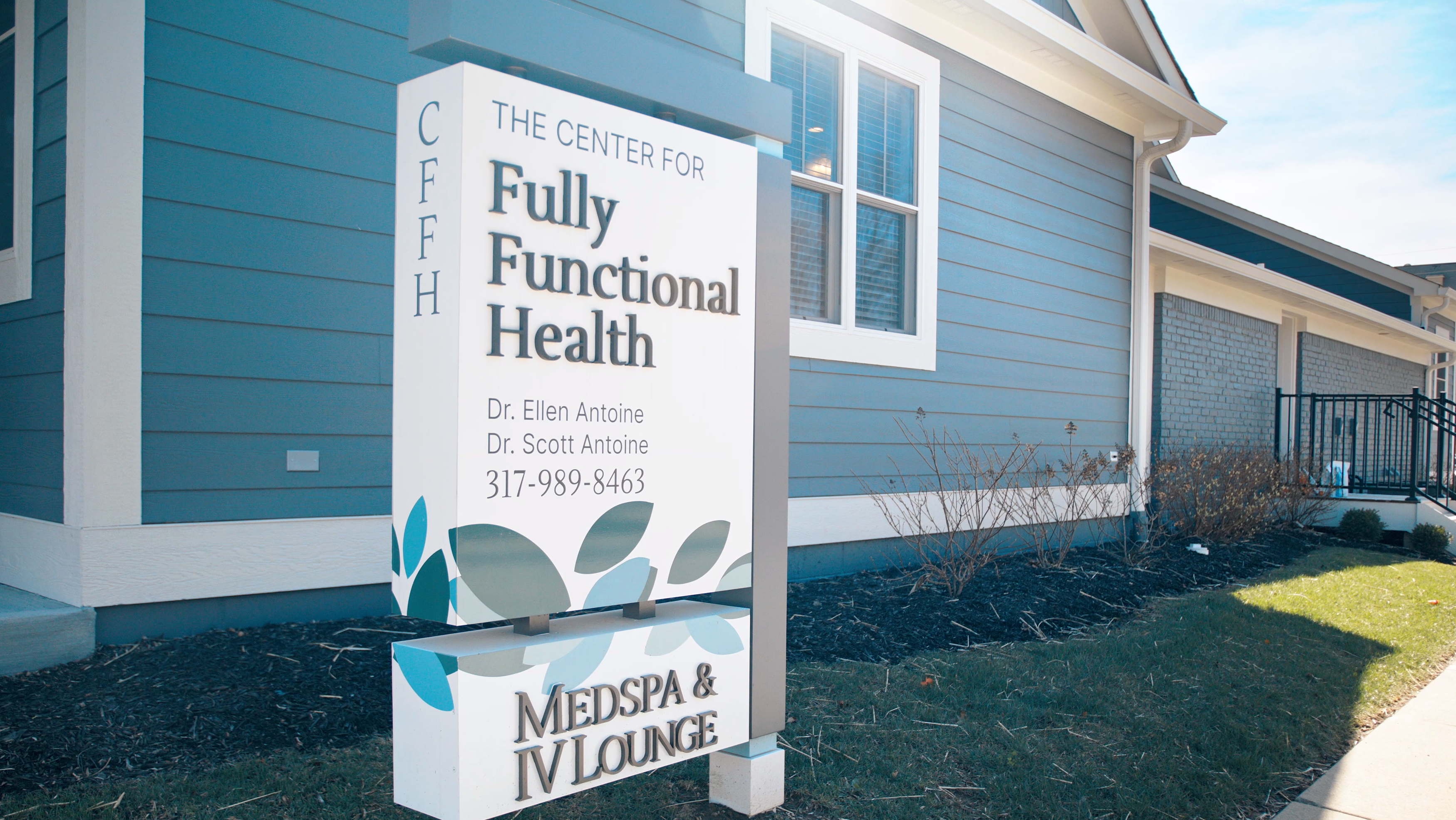 Outdoor sign for 'The Center for Fully Functional Health' in front of a building.
